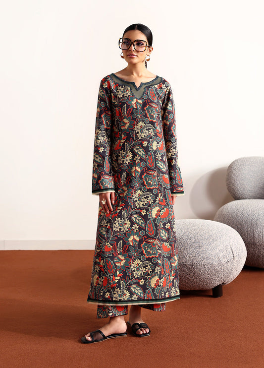 Model wearing Terrie from Gulaal in a dark green printed co-ord set with red and beige floral motifs, ideal for Pakistani luxury pret in the UK.