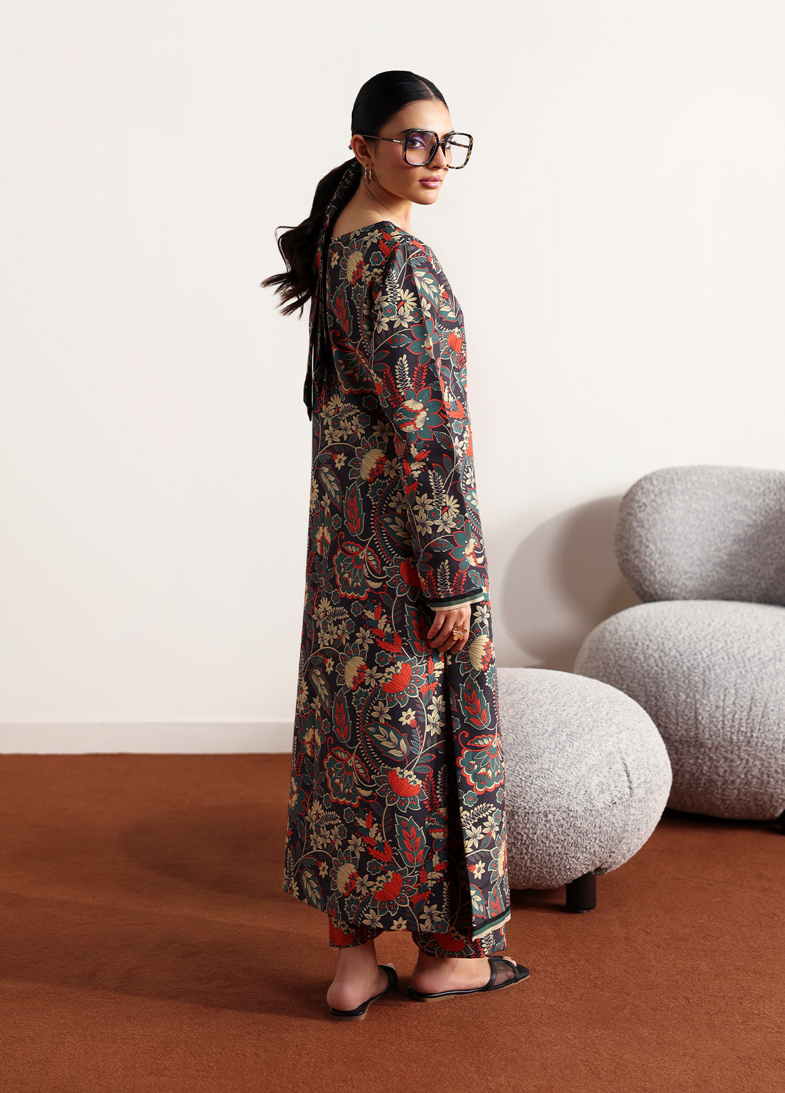 Model wearing Terrie from Gulaal in a dark green printed co-ord set with red and beige floral motifs, ideal for Pakistani luxury pret in the UK.