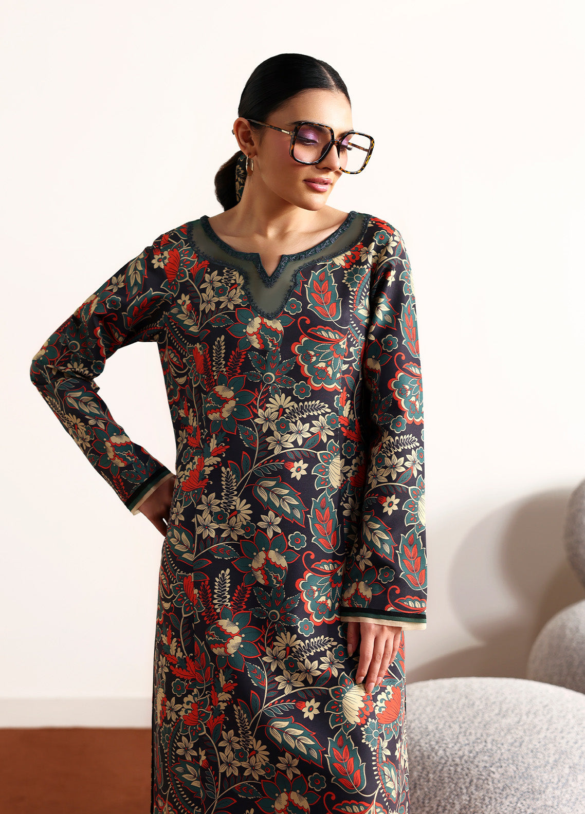 Model wearing Terrie from Gulaal in a dark green printed co-ord set with red and beige floral motifs, ideal for Pakistani luxury pret in the UK.
