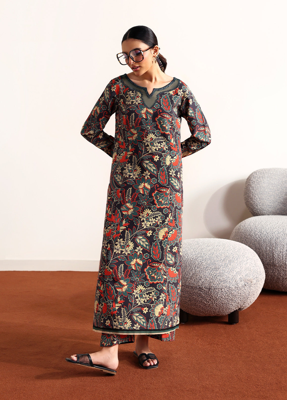 Model wearing Terrie from Gulaal in a dark green printed co-ord set with red and beige floral motifs, ideal for Pakistani luxury pret in the UK.