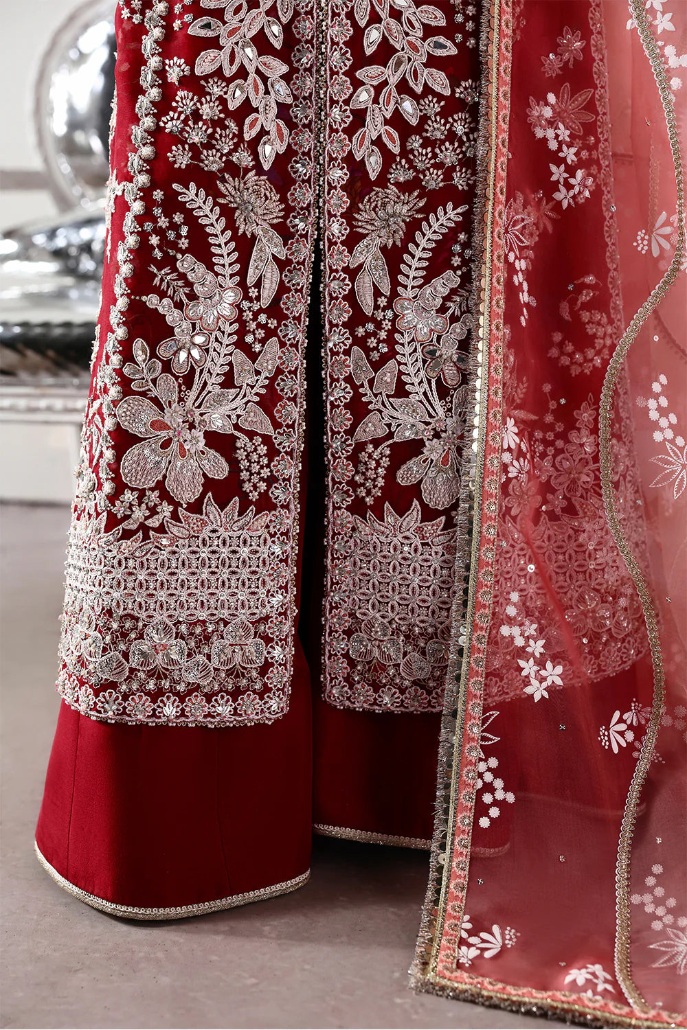 Model wearing Solara by Soraya in deep red with heavy white embroidery and peach dupatta – Pakistani luxury pret, shop online in UK.
