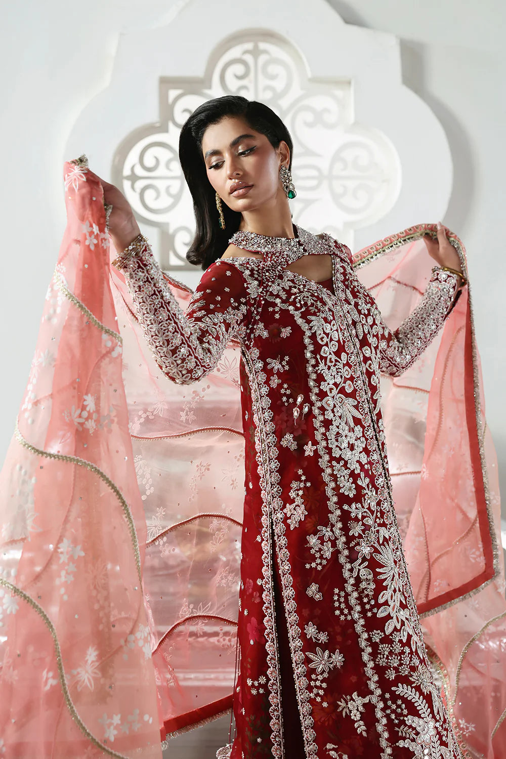 Model wearing Solara by Soraya in deep red with heavy white embroidery and peach dupatta – Pakistani luxury pret, shop online in UK.
