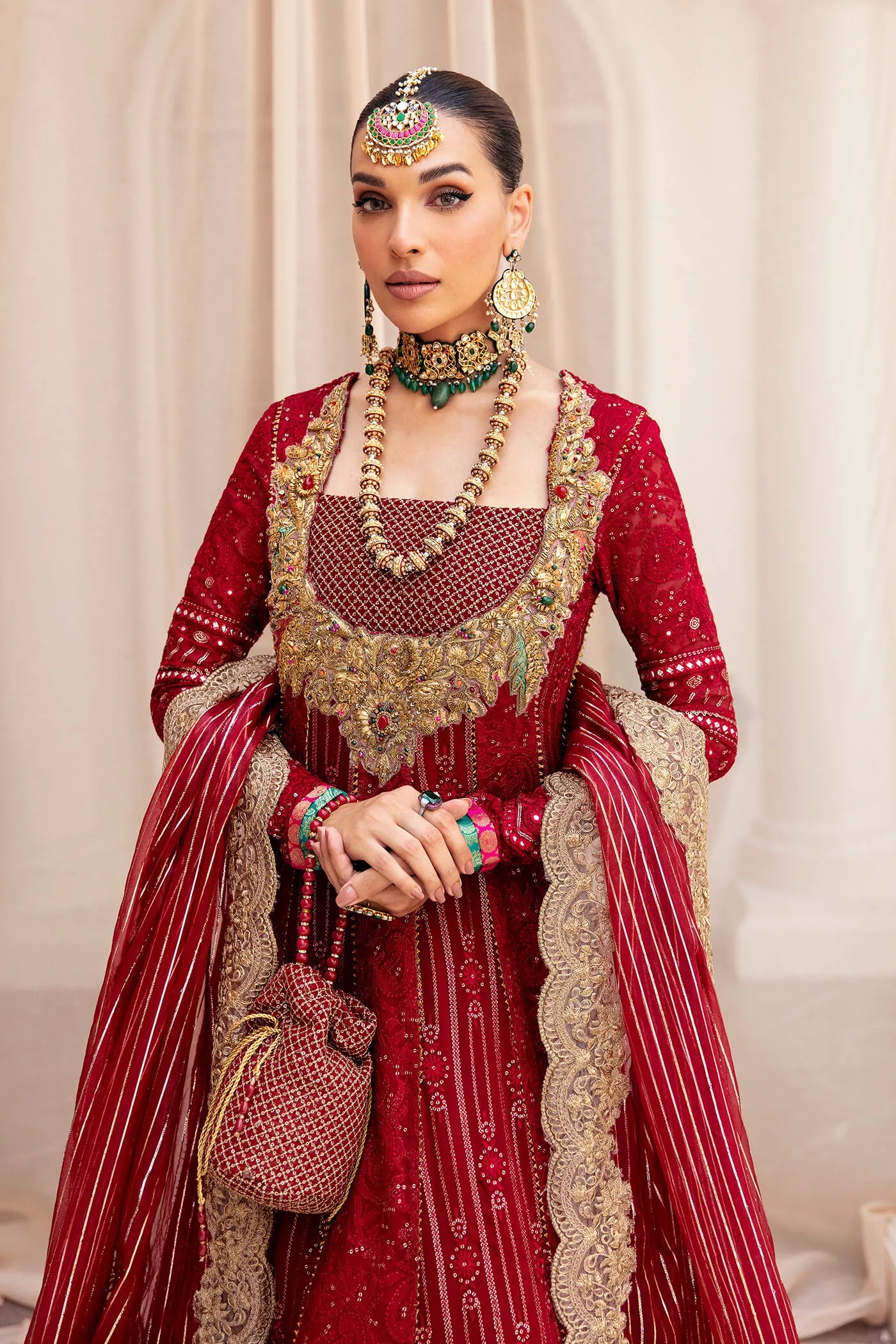 Model wearing a luxurious deep red SCARLET ELEGANCE dress from Musferah Saad's Symphony '23 collection, highlighting Pakistani clothes online in the UK.