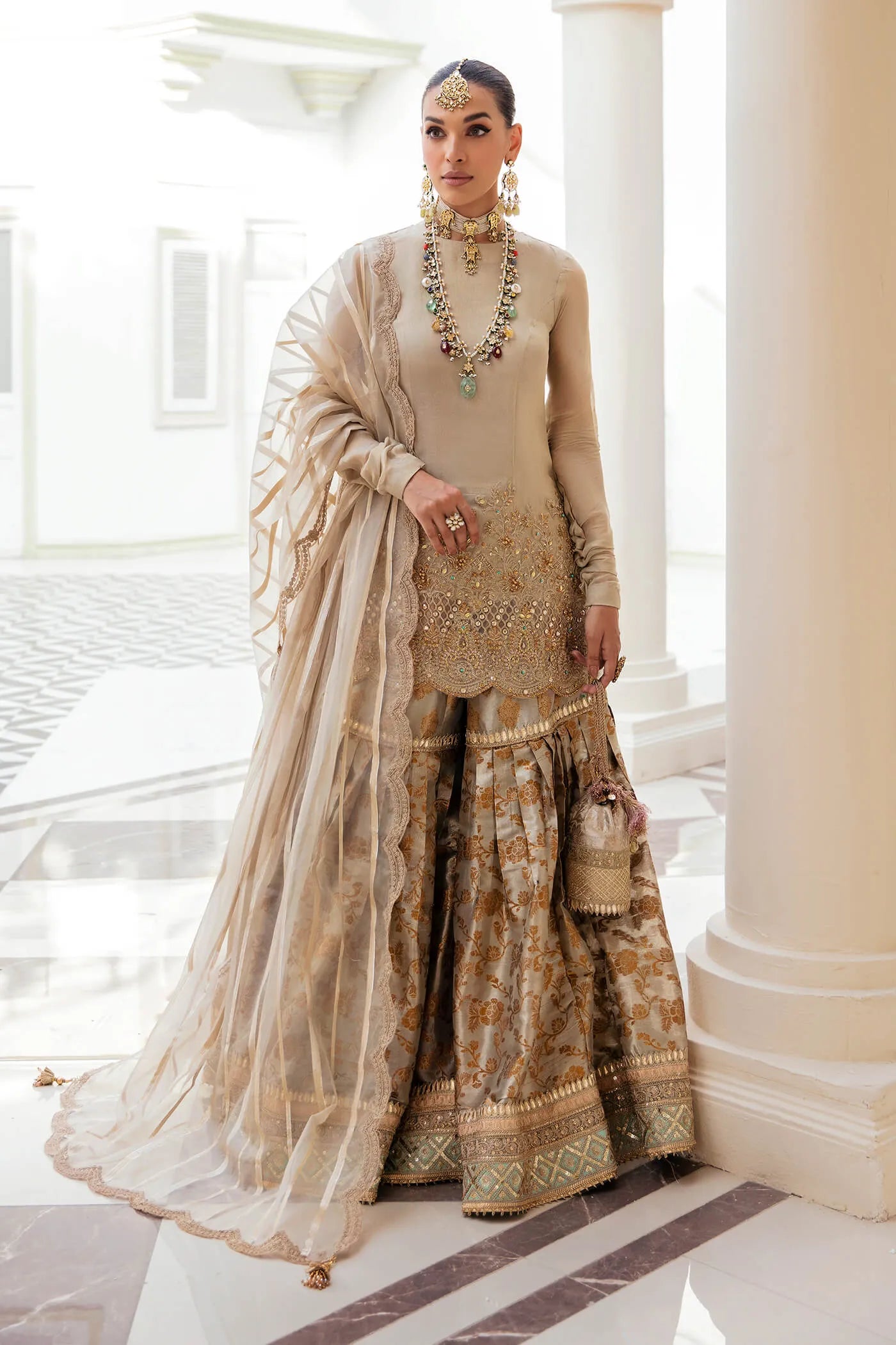 Model wearing a stunning beige MAJESTIC OPULENCE dress from Musferah Saad's Symphony '23 collection, featuring intricate embroidery. Perfect for Pakistani clothes online in the UK.