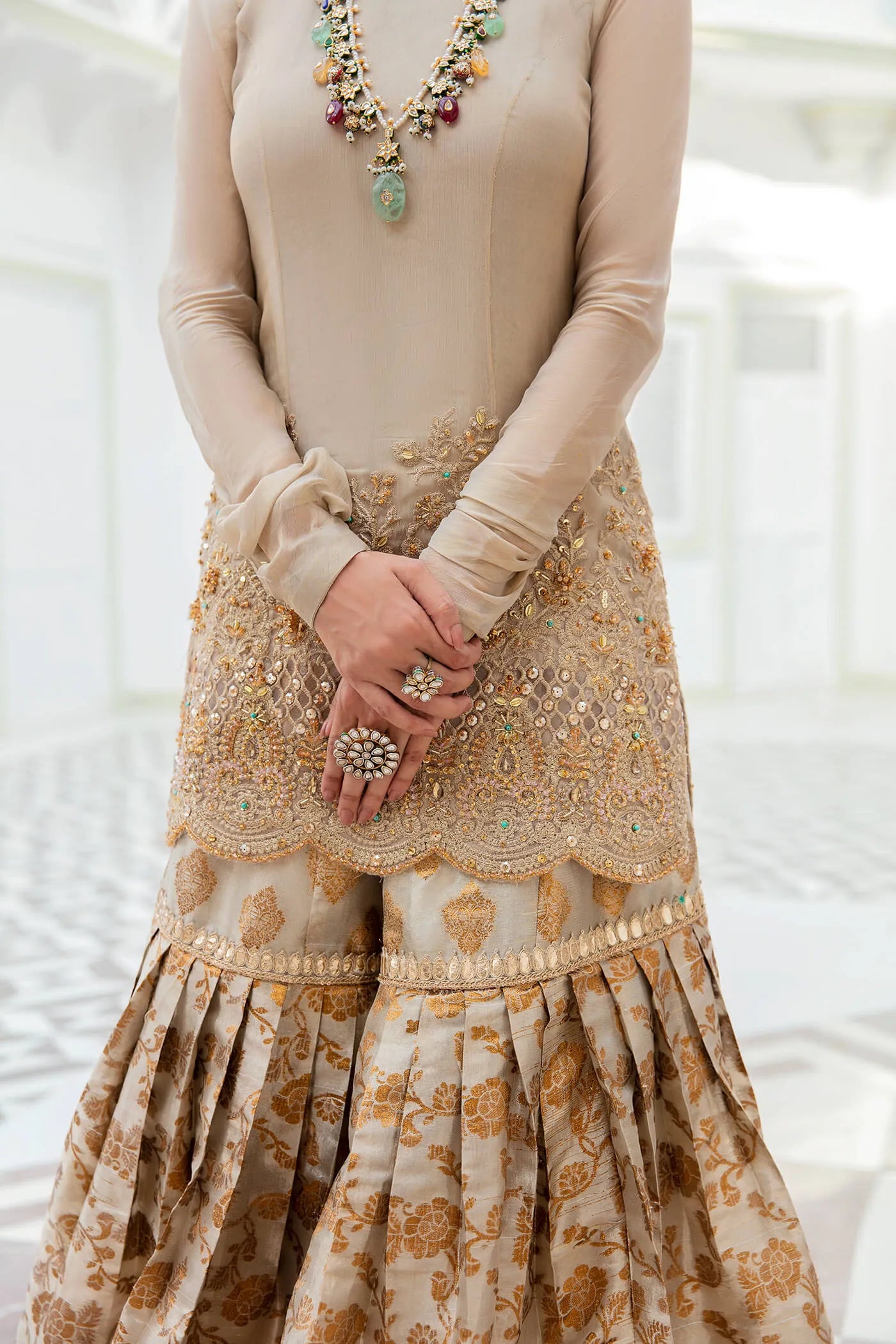 Model wearing a stunning beige MAJESTIC OPULENCE dress from Musferah Saad's Symphony '23 collection, featuring intricate embroidery. Perfect for Pakistani clothes online in the UK.