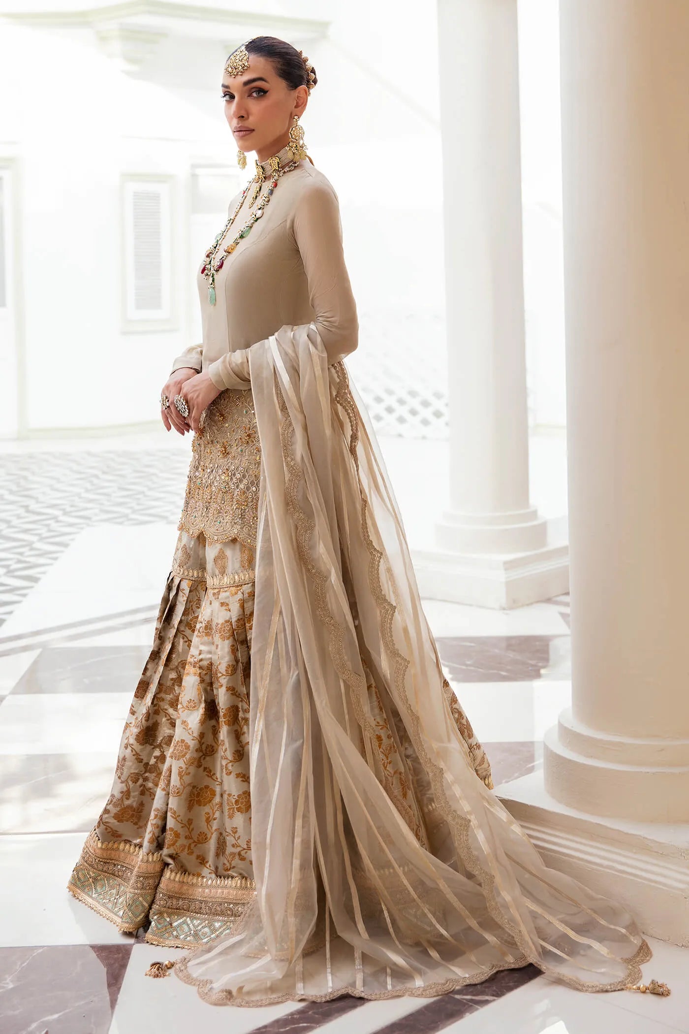 Model wearing a stunning beige MAJESTIC OPULENCE dress from Musferah Saad's Symphony '23 collection, featuring intricate embroidery. Perfect for Pakistani clothes online in the UK.