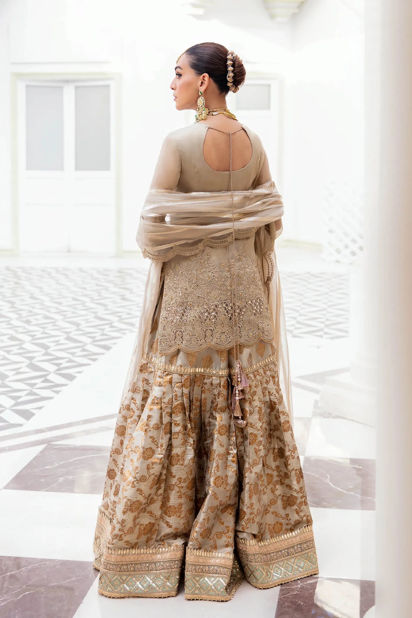 Model wearing a stunning beige MAJESTIC OPULENCE dress from Musferah Saad's Symphony '23 collection, featuring intricate embroidery. Perfect for Pakistani clothes online in the UK.