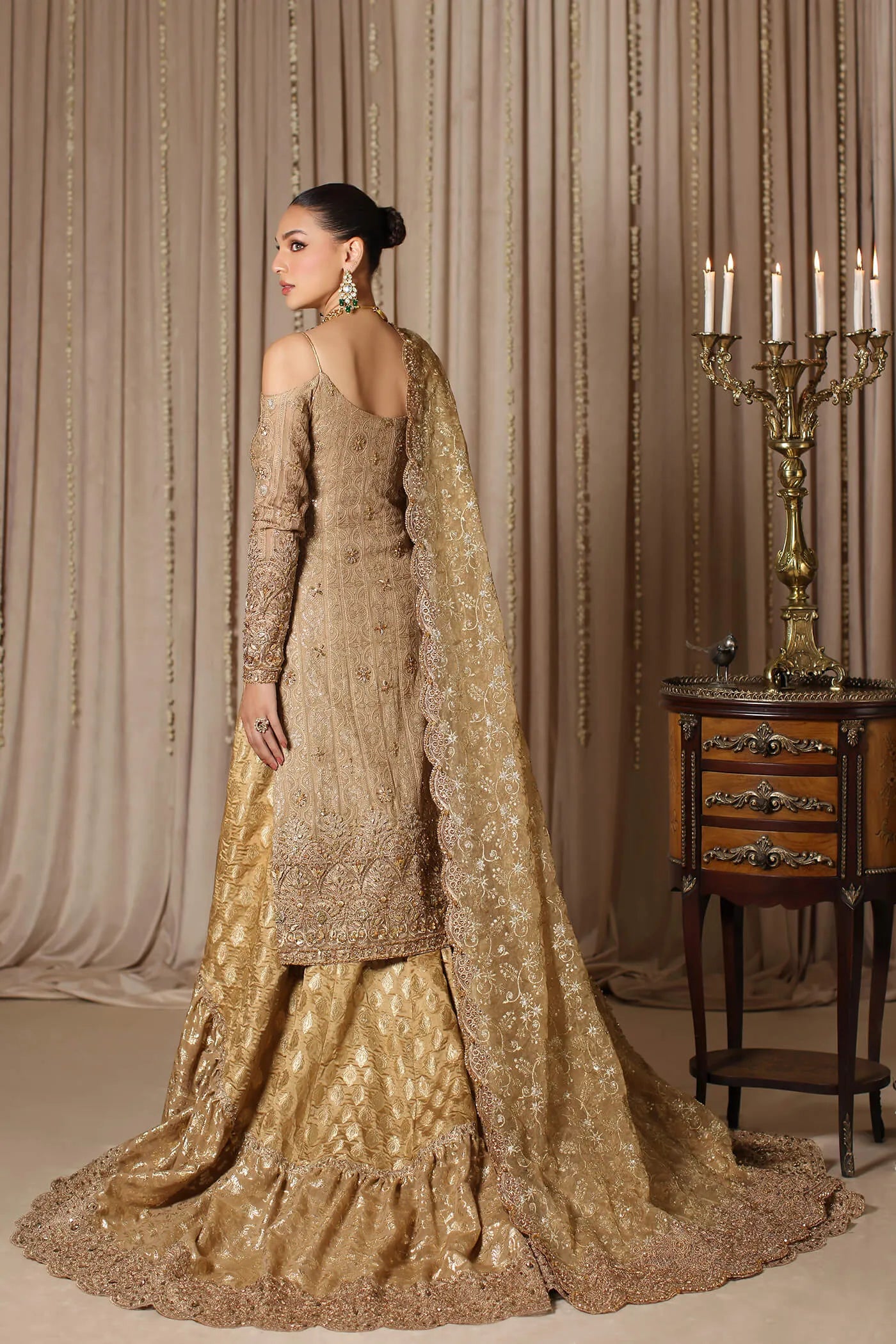 Model wearing a gold CELESTIAL CROWN dress from Musferah Saad's The Modern Maharani '23 collection, showcasing Pakistani clothes online in the UK.