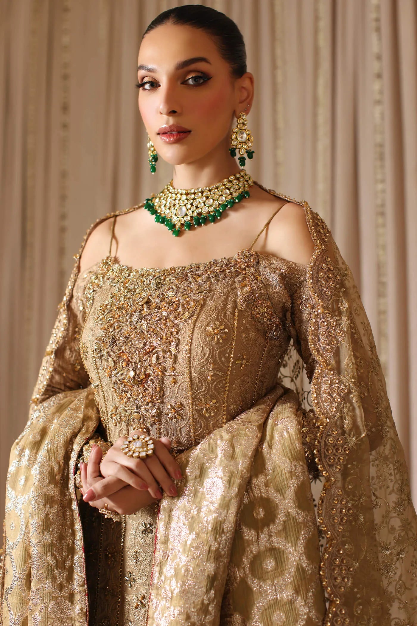 Model wearing a gold CELESTIAL CROWN dress from Musferah Saad's The Modern Maharani '23 collection, showcasing Pakistani clothes online in the UK.