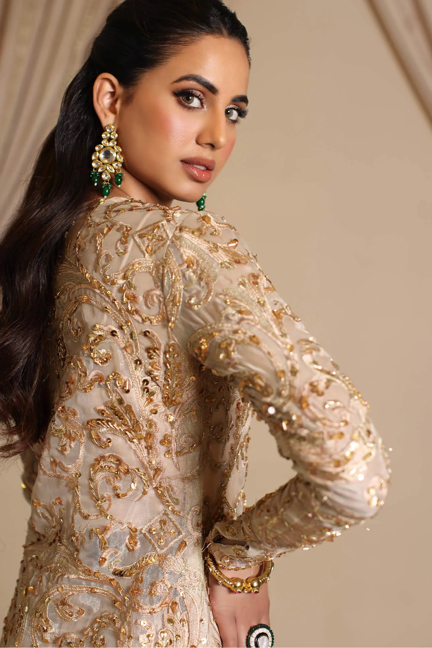 Model wearing Musferah Saad Golden Mirage, an elegant Pakistani bridal dress in UK.