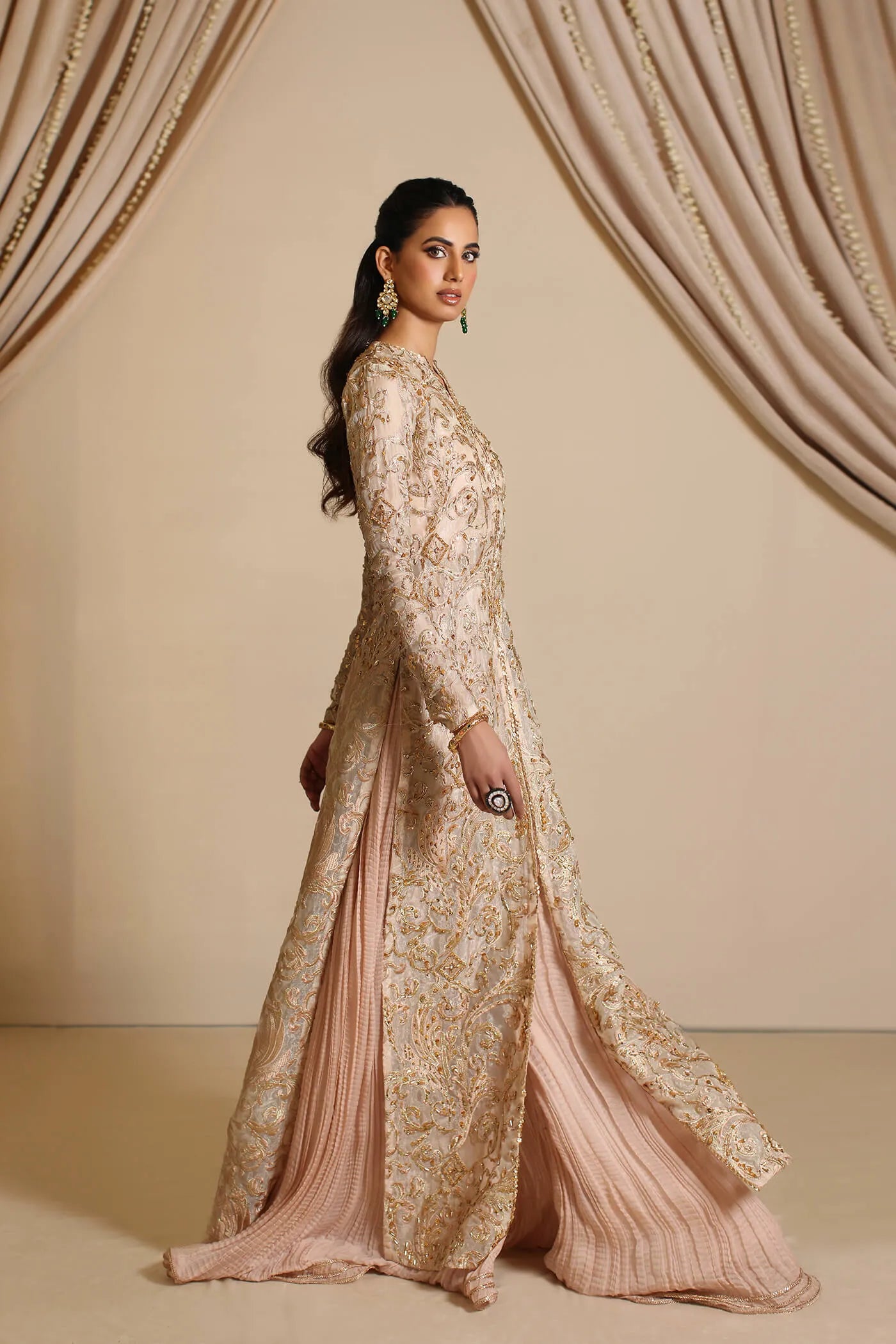 Model wearing Musferah Saad Golden Mirage, an elegant Pakistani bridal dress in UK.