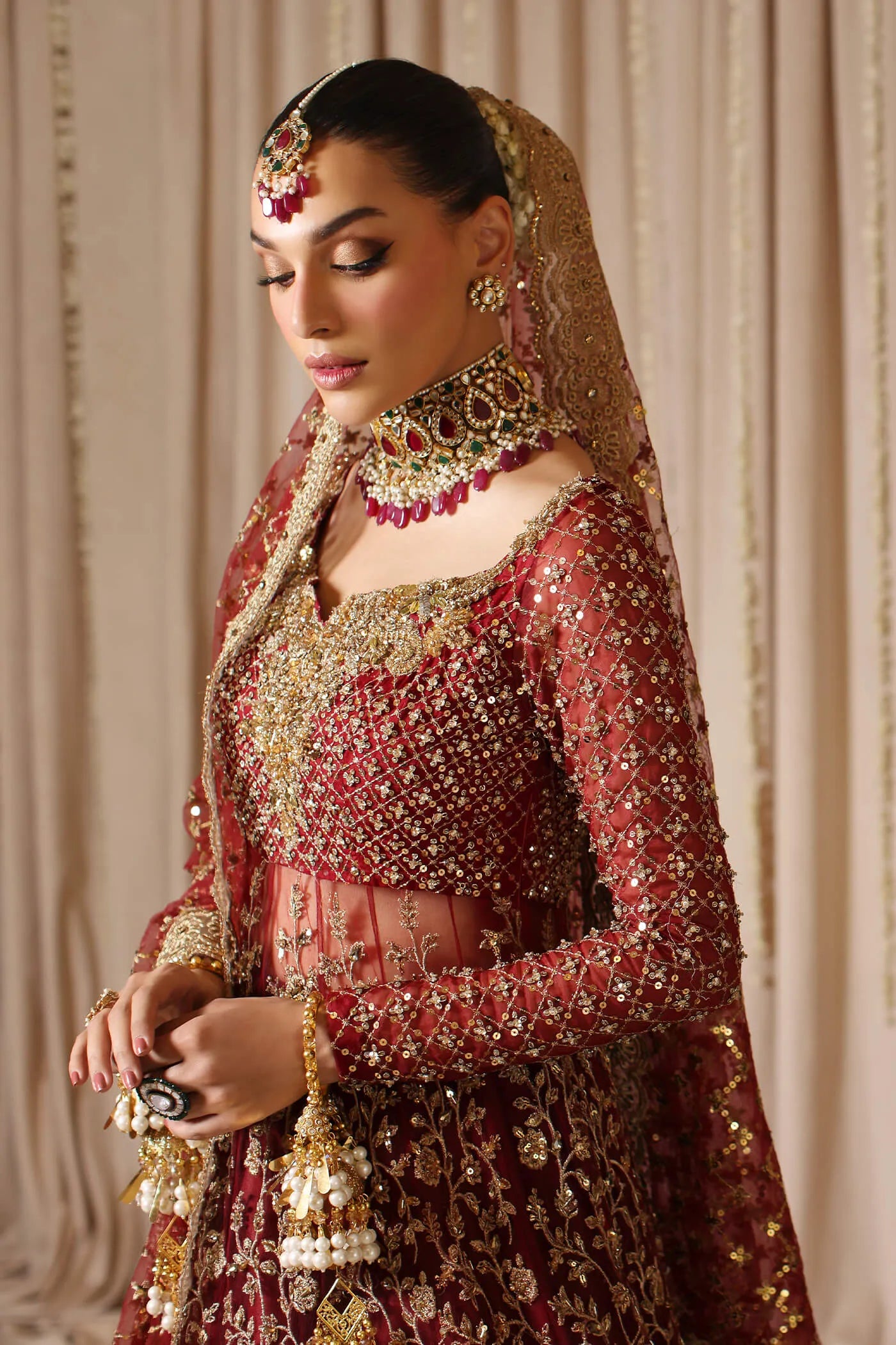 Model wearing a maroon MAHARANI dress from Musferah Saad's The Modern Maharani '23 collection, showcasing Pakistani clothes online in the UK.