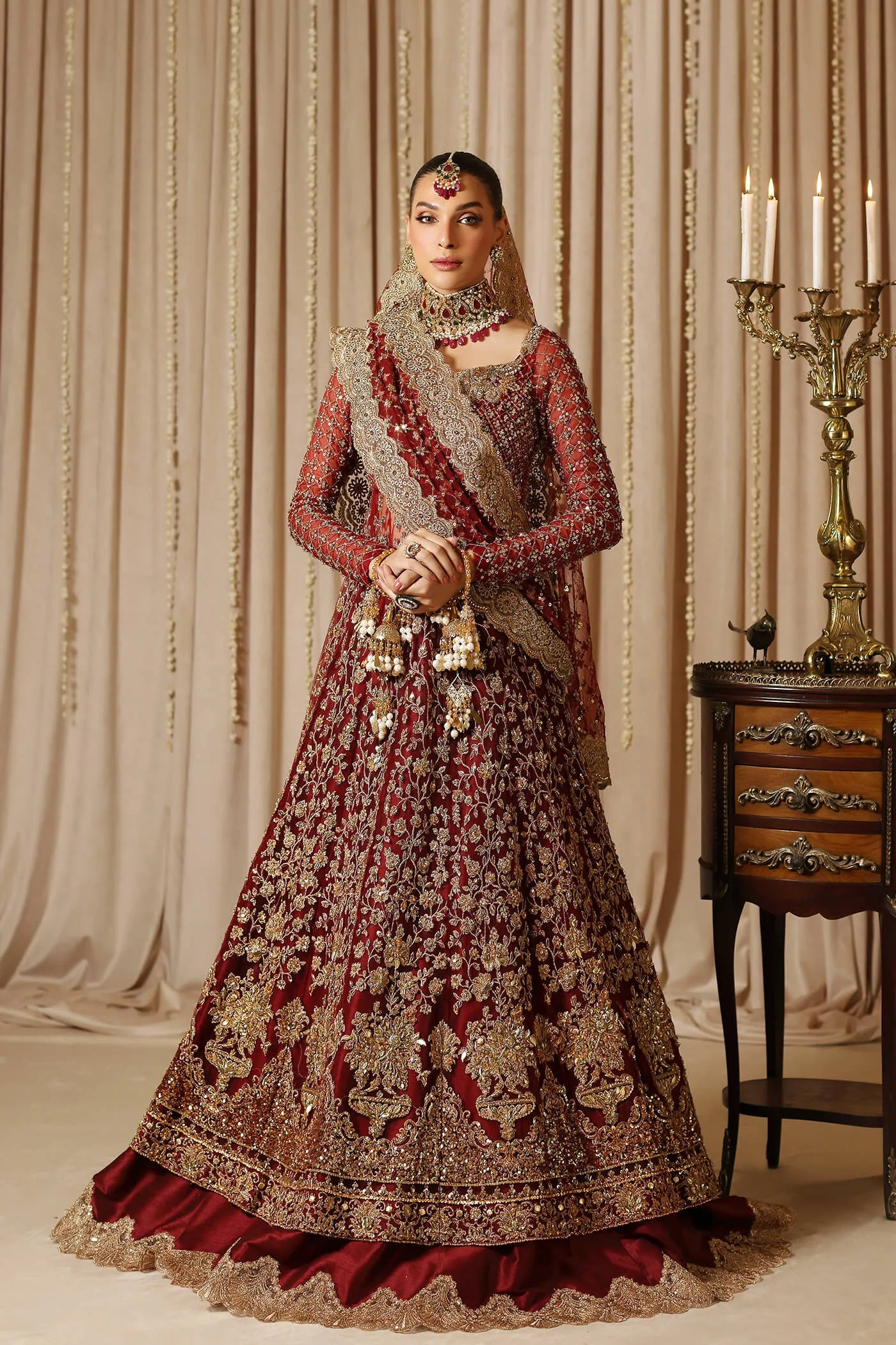 Model wearing a maroon MAHARANI dress from Musferah Saad's The Modern Maharani '23 collection, showcasing Pakistani clothes online in the UK.