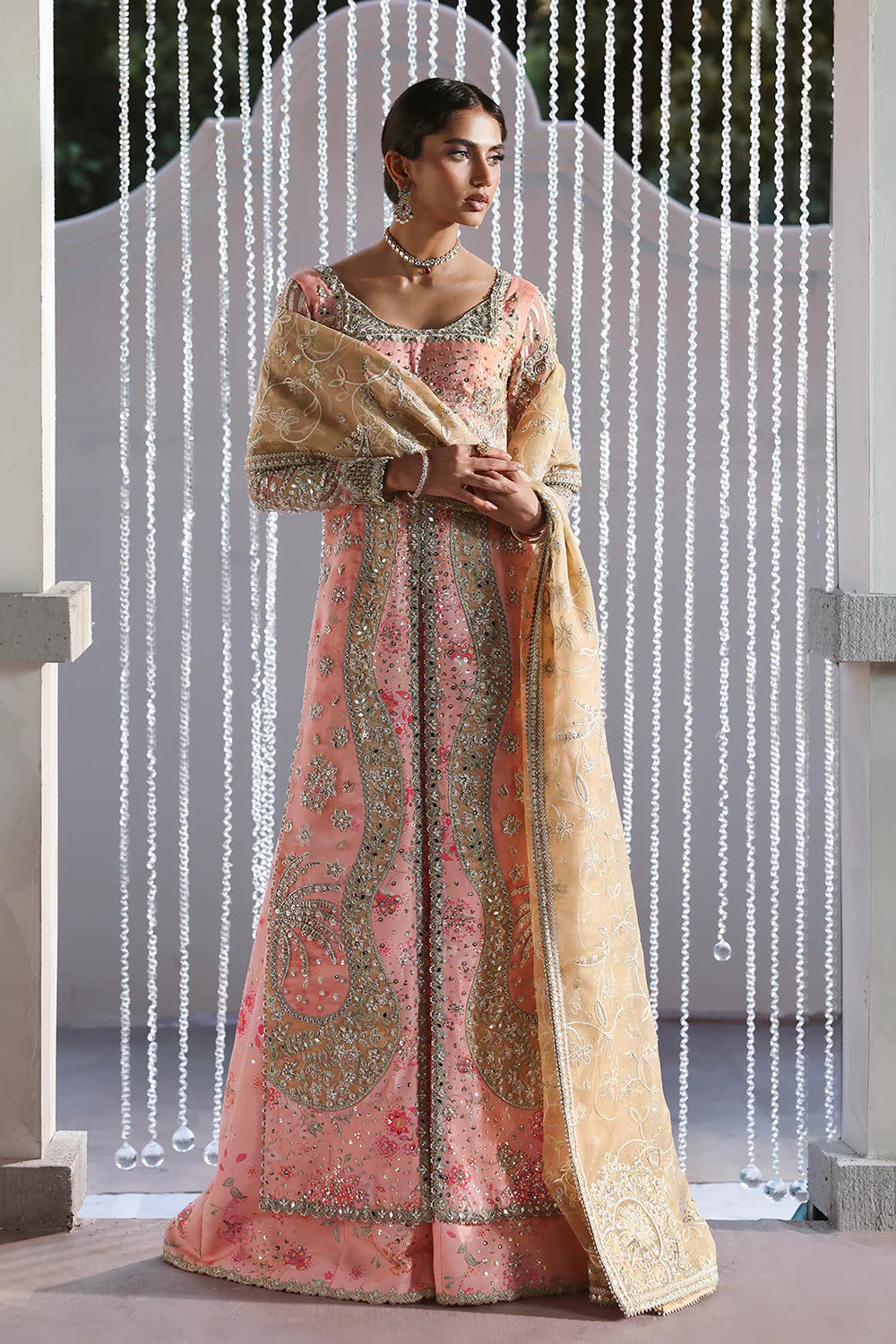 Model wearing Velora by Soraya in soft peach and gold embroidered gown – Pakistani luxury pret for weddings, shop Pakistani clothes online in UK.

