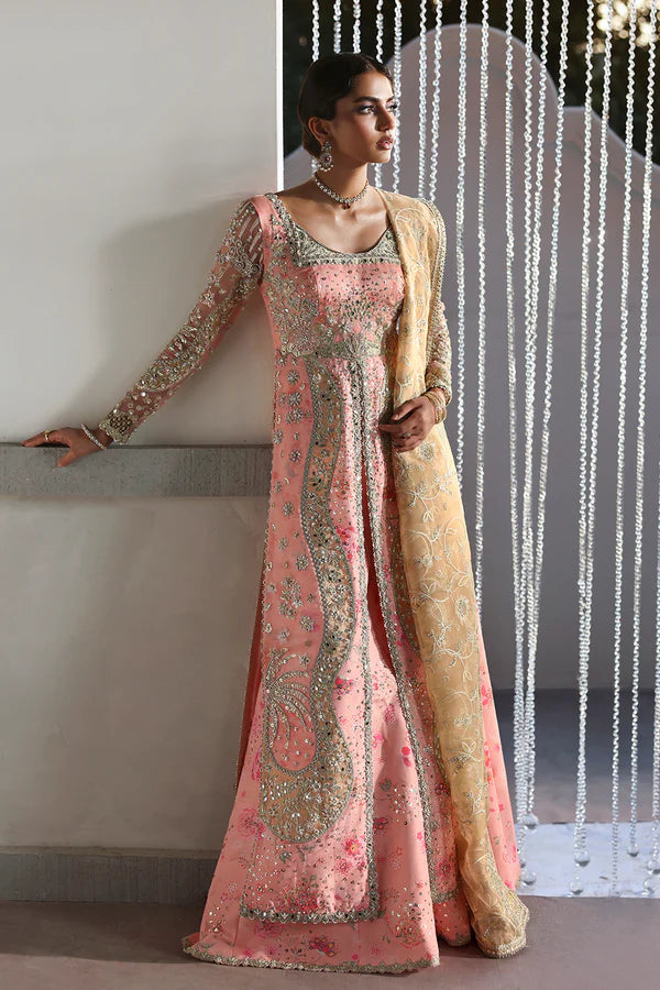 Model wearing Velora by Soraya in soft peach and gold embroidered gown – Pakistani luxury pret for weddings, shop Pakistani clothes online in UK.
