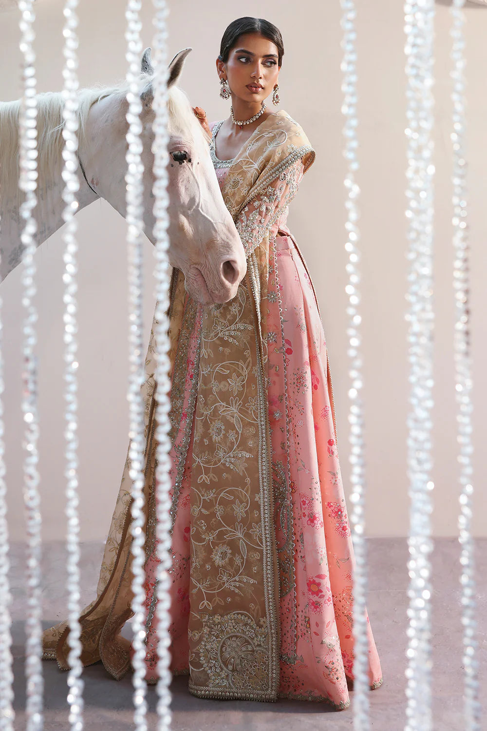 Model wearing Velora by Soraya in soft peach and gold embroidered gown – Pakistani luxury pret for weddings, shop Pakistani clothes online in UK.
