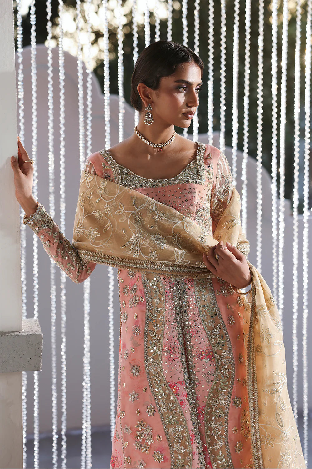 Model wearing Velora by Soraya in soft peach and gold embroidered gown – Pakistani luxury pret for weddings, shop Pakistani clothes online in UK.
