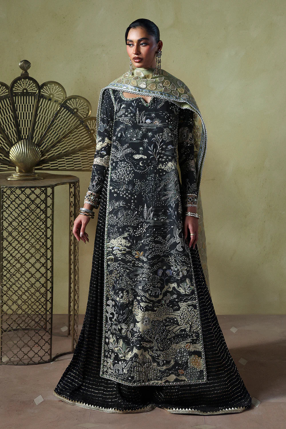 Model wearing Zyra by Soraya in deep black with intricate silver embroidery – Pakistani luxury pret, shop Pakistani clothes online in UK.
