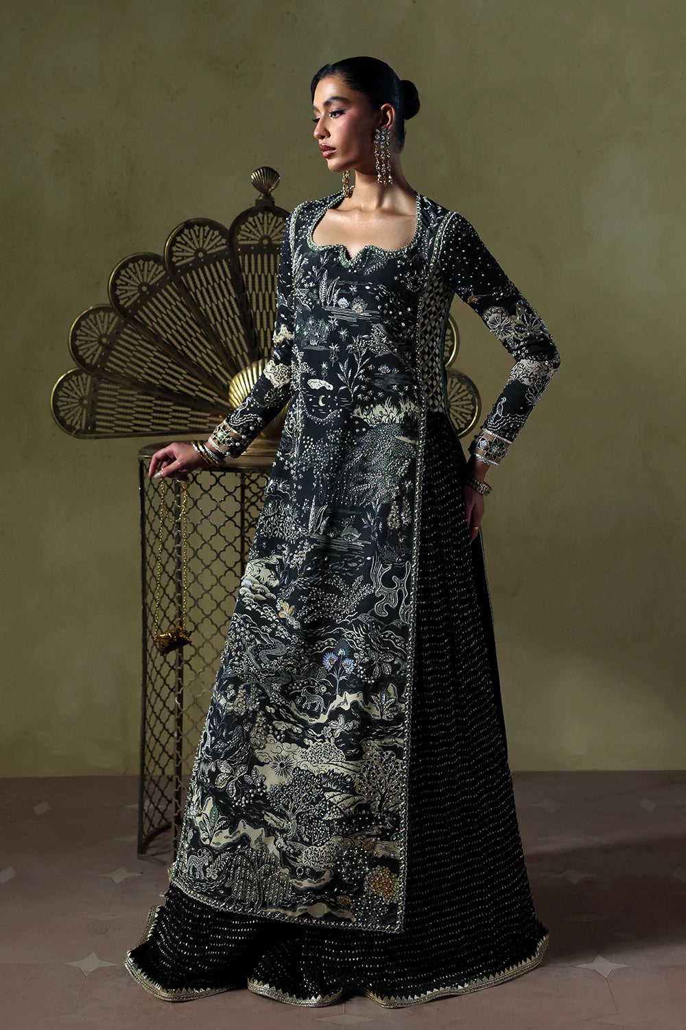 Model wearing Zyra by Soraya in deep black with intricate silver embroidery – Pakistani luxury pret, shop Pakistani clothes online in UK.
