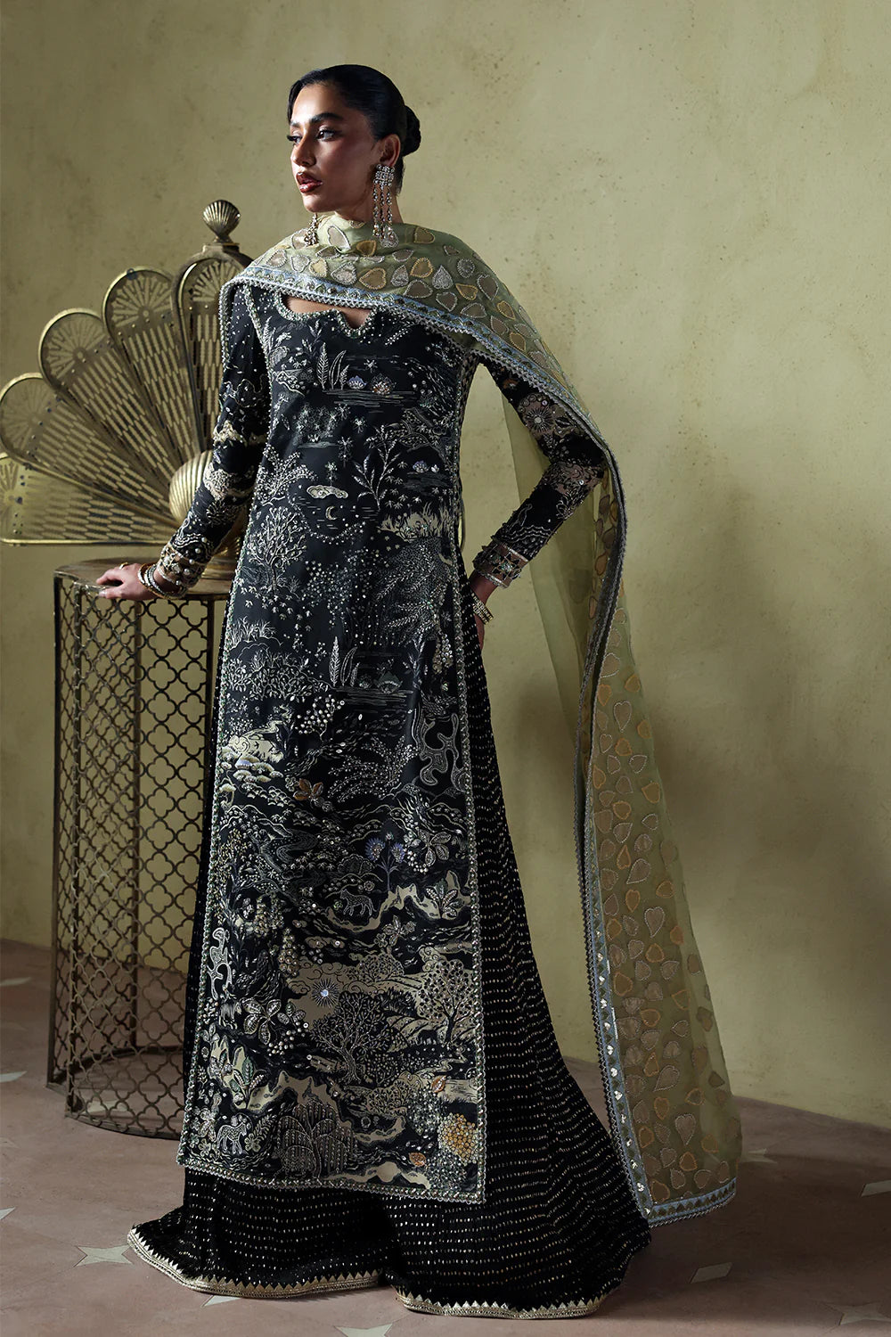 Model wearing Zyra by Soraya in deep black with intricate silver embroidery – Pakistani luxury pret, shop Pakistani clothes online in UK.
