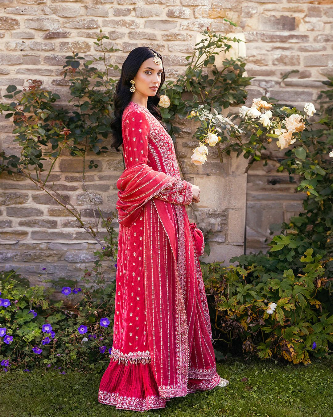 Model wearing Alannah from Faiza Saqlain's Adeen Velvet '24 collection in rich maroon. Luxury pret, festive, Pakistani clothes online in UK.