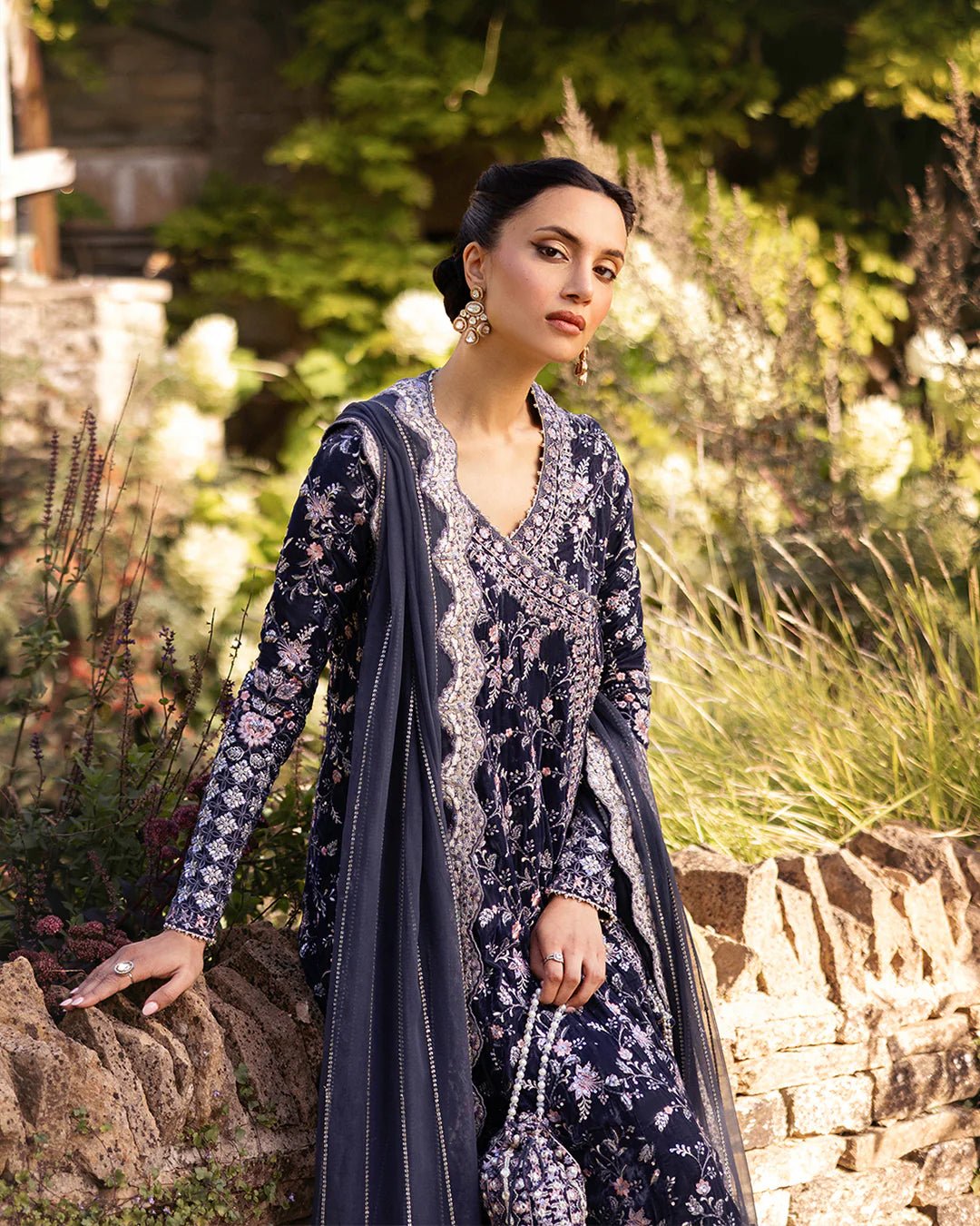 Model wearing Darcel from Faiza Saqlain's Adeen Velvet '24 collection in rich navy blue. Luxury pret, festive, Pakistani clothes online in UK.