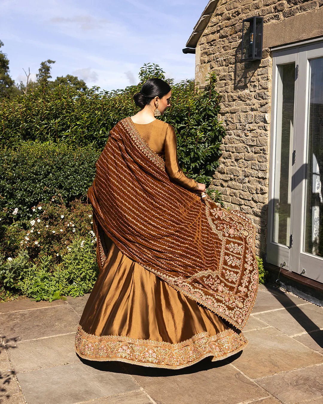 Model wearing Emera from Faiza Saqlain's Adeen Velvet '24 collection in deep emerald green. Luxury pret, festive, Pakistani clothes online in UK.