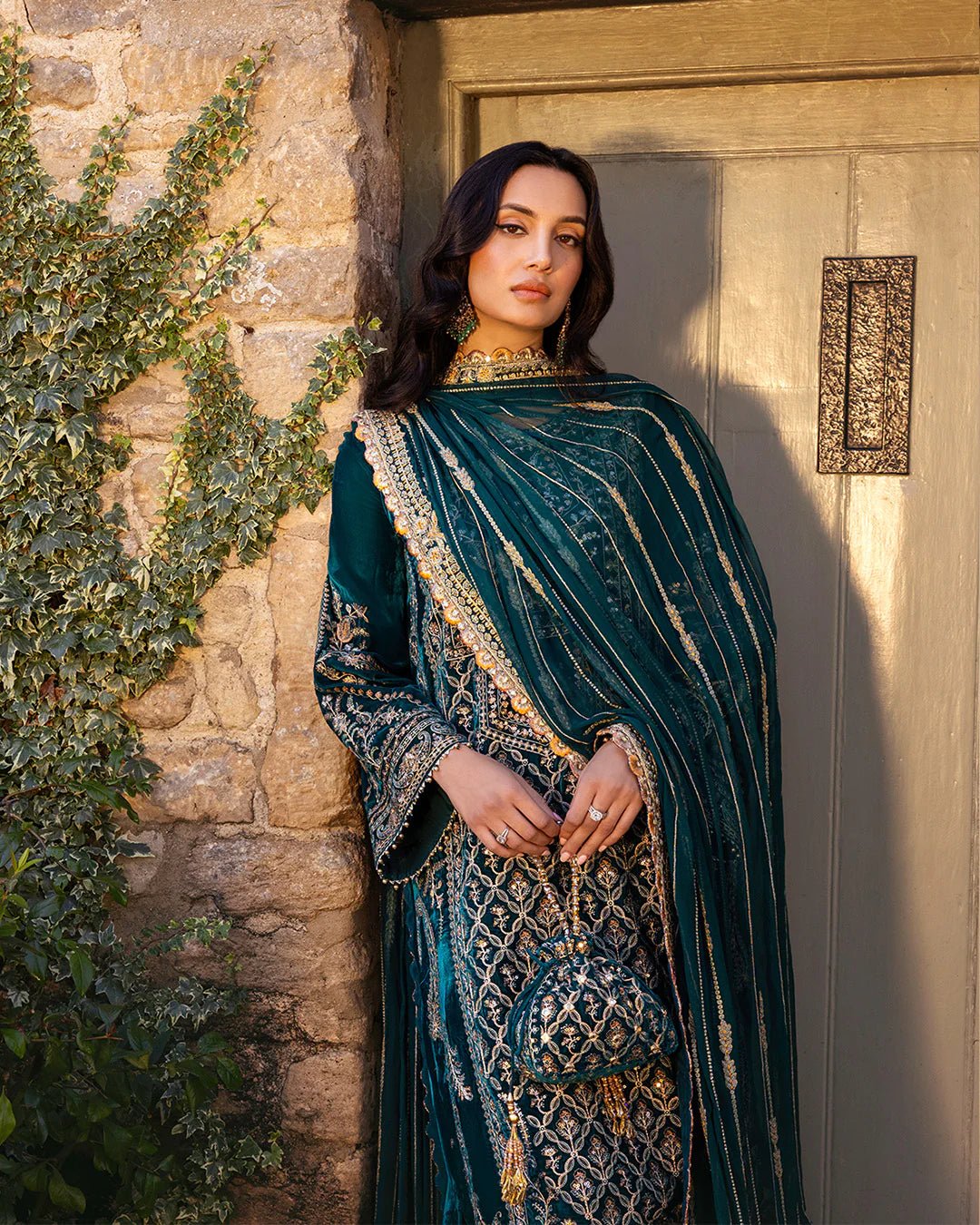 Model wearing Merna from Faiza Saqlain's Adeen Velvet '24 collection in teal green. Luxury pret, festive, Pakistani clothes online in UK.