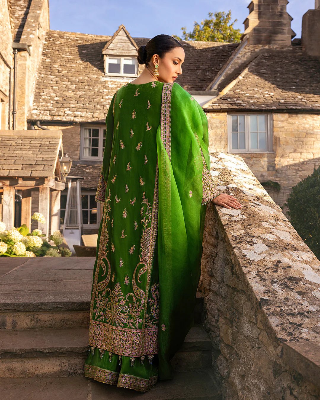 Model wearing Tegan from Faiza Saqlain's Adeen Velvet '24 collection in opulent emerald green. Luxury pret, festive, Pakistani clothes online in UK.