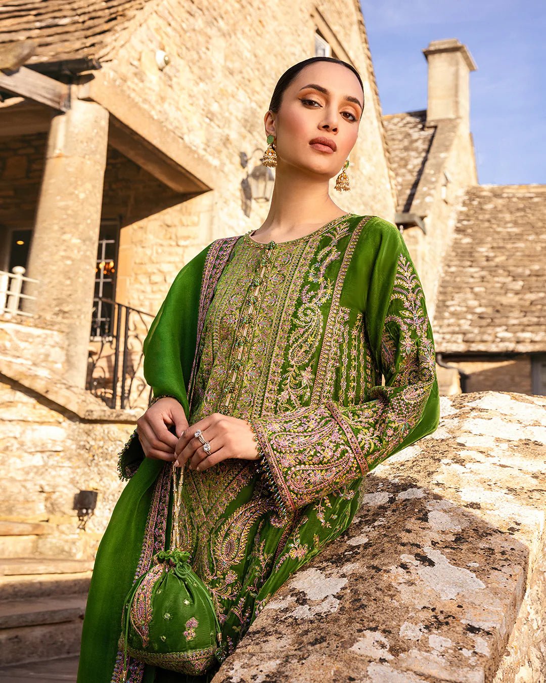 Model wearing Tegan from Faiza Saqlain's Adeen Velvet '24 collection in opulent emerald green. Luxury pret, festive, Pakistani clothes online in UK.