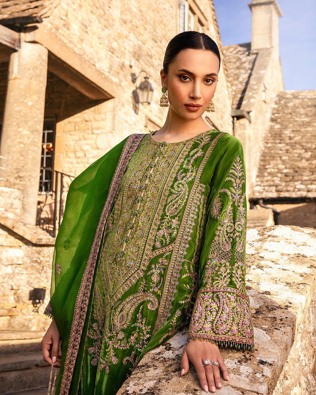 Model wearing Tegan from Faiza Saqlain's Adeen Velvet '24 collection in opulent emerald green. Luxury pret, festive, Pakistani clothes online in UK.