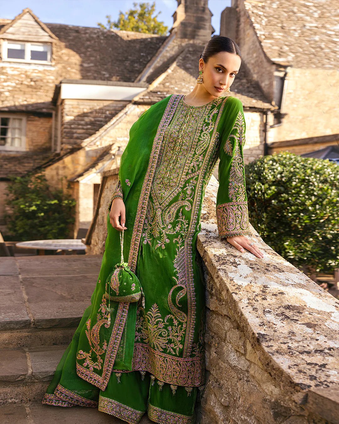 Model wearing Tegan from Faiza Saqlain's Adeen Velvet '24 collection in opulent emerald green. Luxury pret, festive, Pakistani clothes online in UK.