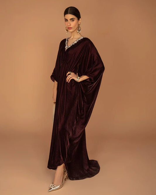 Model wearing a burgundy Adiba dress from Faiza Saqlain's Aleira Evening Edit '24 collection. Pakistani clothes online in UK.