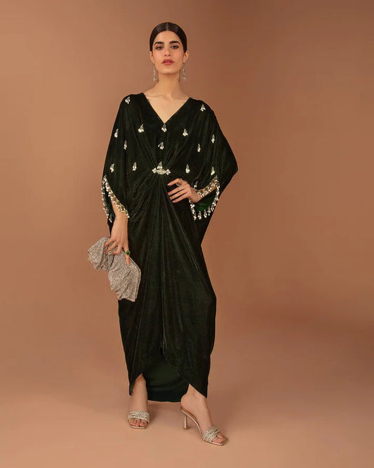 Model wearing a green Perin dress from Faiza Saqlain's Aleira Evening Edit '24 collection. Pakistani clothes online in UK.