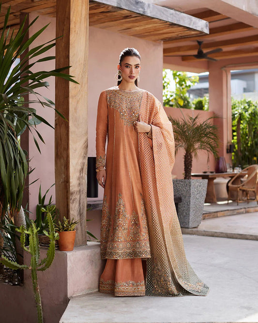 Model wearing a rust-colored Dalisay dress from Faiza Saqlain's Lenora Luxury Pret '24 collection. Pakistani clothes online in UK.