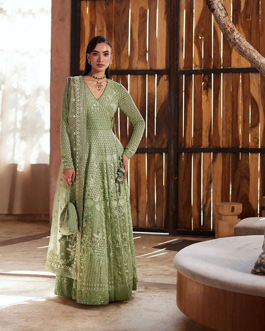Model wearing a green Eiraam dress from Faiza Saqlain's Lenora Luxury Pret '24 collection. Pakistani clothes online in UK.
