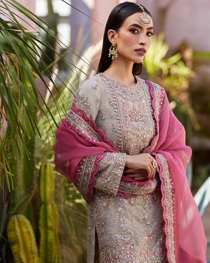 Model wearing a silver Rosaline dress with pink dupatta from Faiza Saqlain's Lenora Luxury Pret '24 collection. Pakistani clothes online in UK.