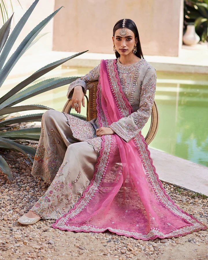 Model wearing a silver Rosaline dress with pink dupatta from Faiza Saqlain's Lenora Luxury Pret '24 collection. Pakistani clothes online in UK.