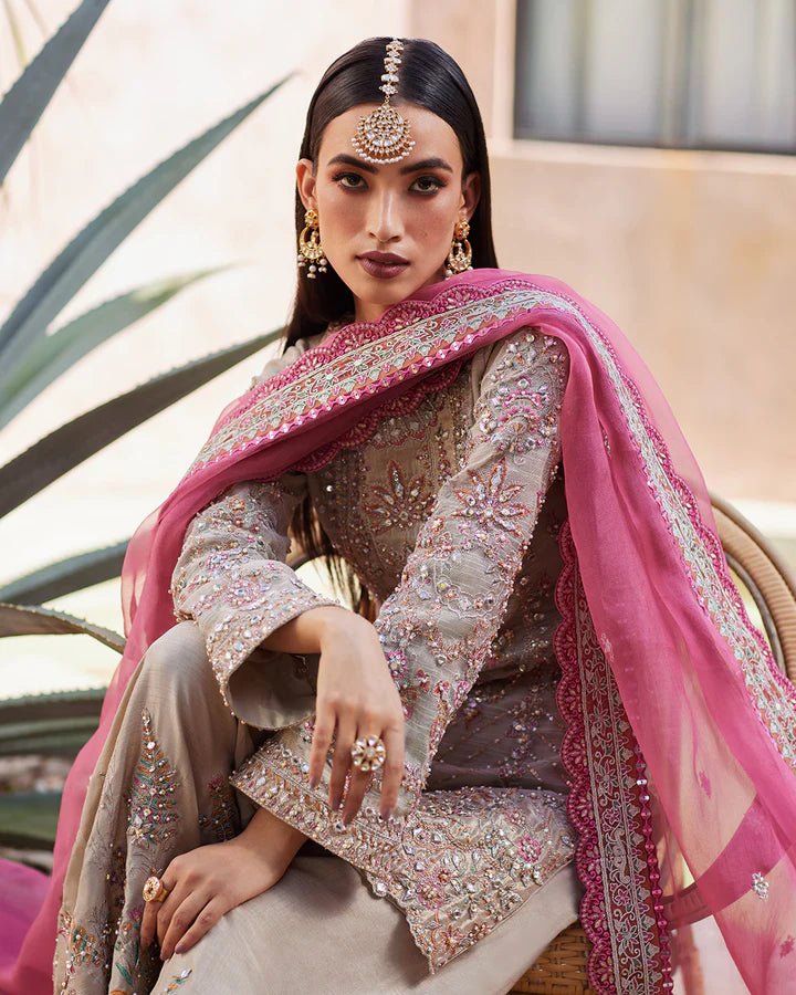 Model wearing a silver Rosaline dress with pink dupatta from Faiza Saqlain's Lenora Luxury Pret '24 collection. Pakistani clothes online in UK.