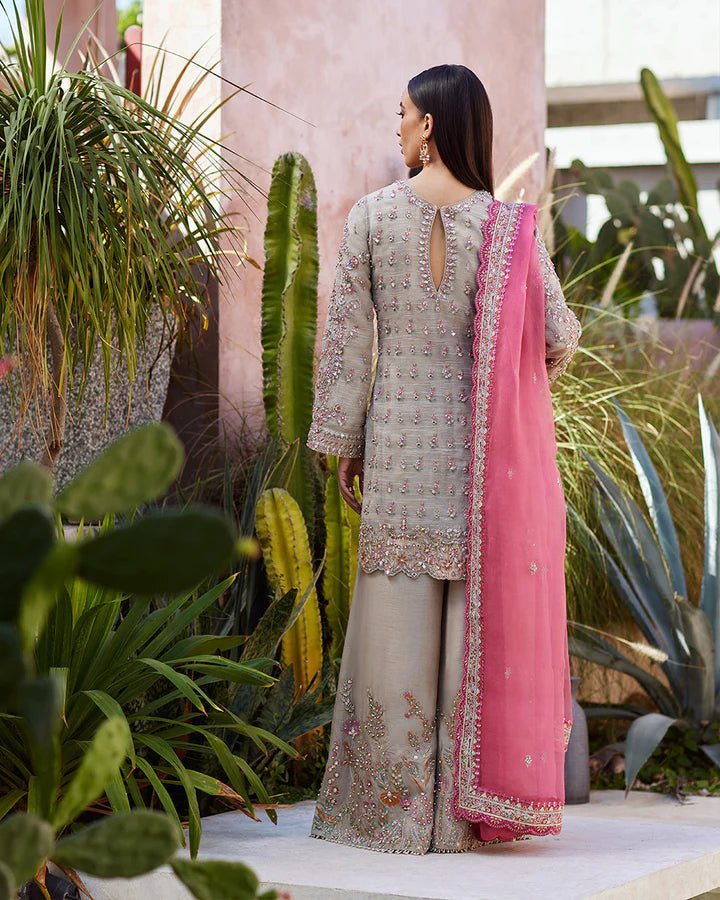 Model wearing a silver Rosaline dress with pink dupatta from Faiza Saqlain's Lenora Luxury Pret '24 collection. Pakistani clothes online in UK.