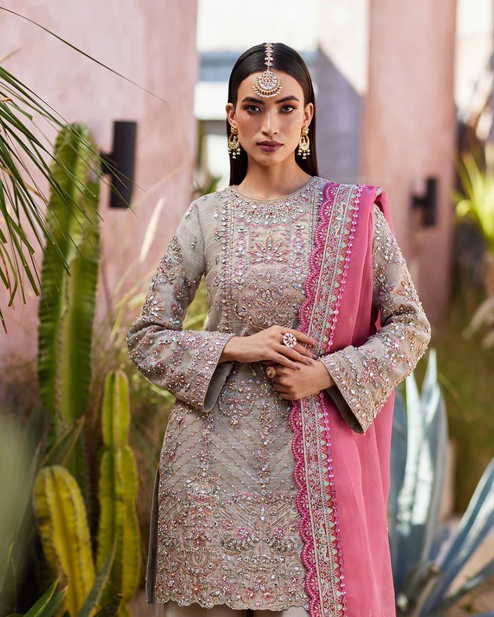 Model wearing a silver Rosaline dress with pink dupatta from Faiza Saqlain's Lenora Luxury Pret '24 collection. Pakistani clothes online in UK.