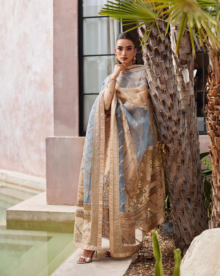 Model wearing a beige and blue Yelena dress from Faiza Saqlain's Lenora Luxury Pret '24 collection. Pakistani clothes online in UK.