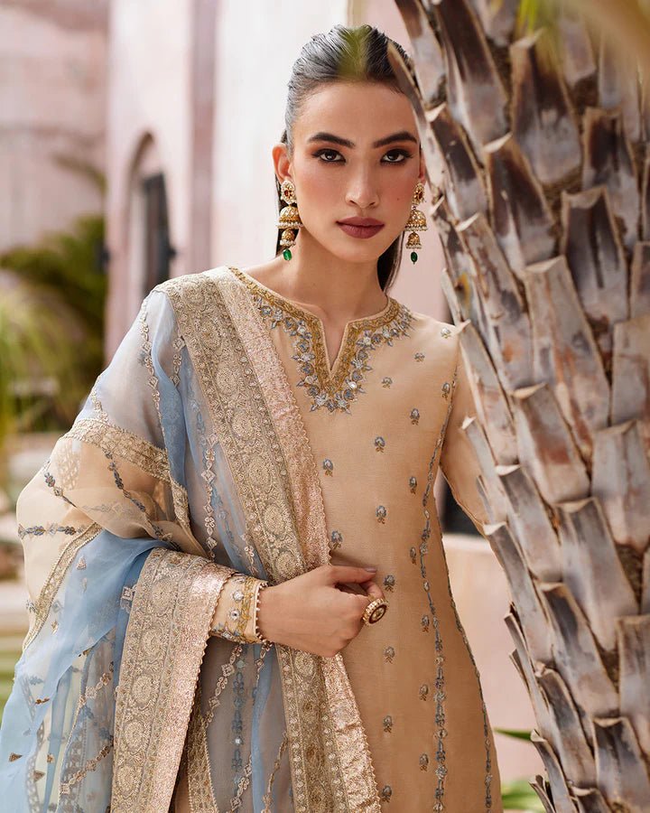 Model wearing a beige and blue Yelena dress from Faiza Saqlain's Lenora Luxury Pret '24 collection. Pakistani clothes online in UK.