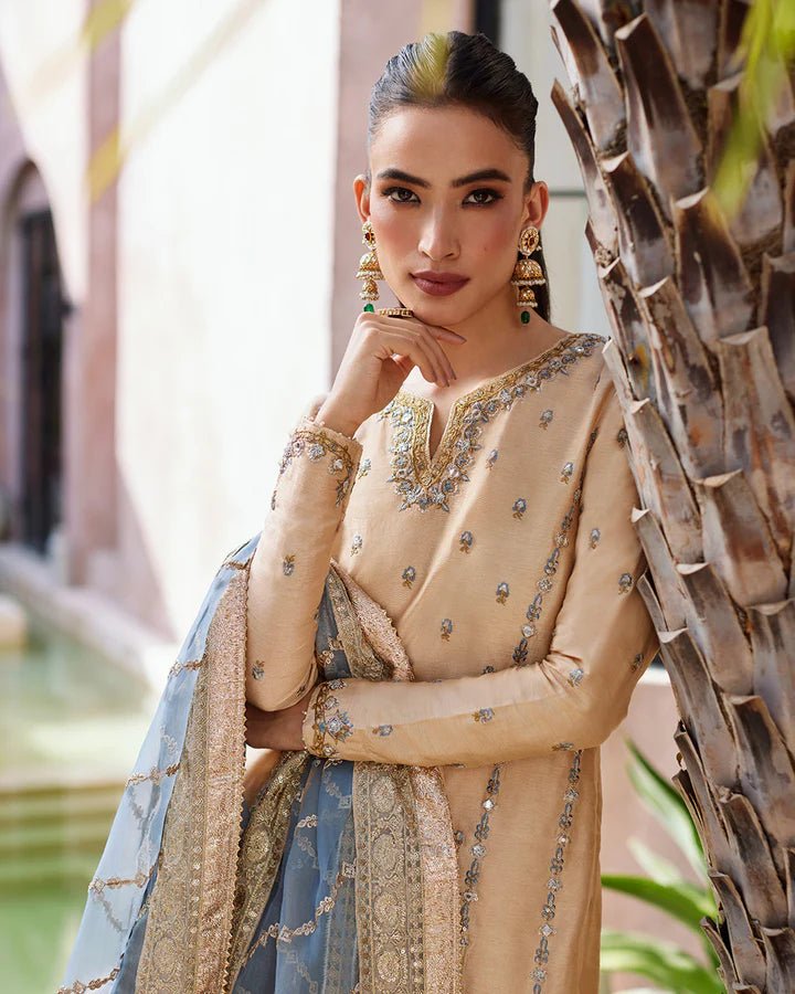 Model wearing a beige and blue Yelena dress from Faiza Saqlain's Lenora Luxury Pret '24 collection. Pakistani clothes online in UK.