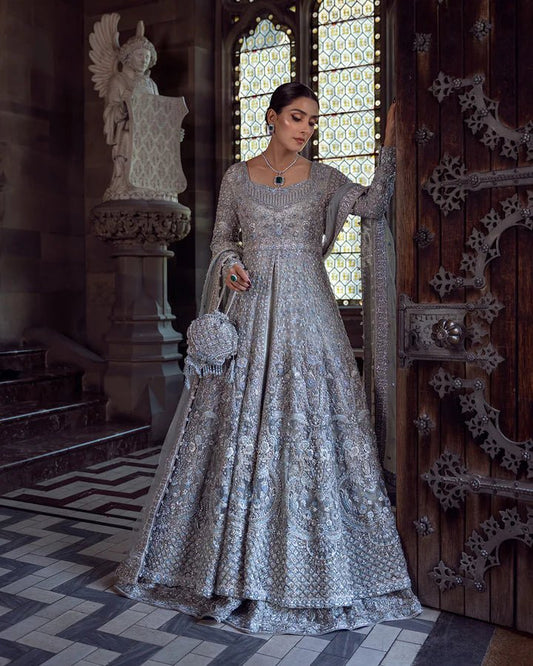 Model wearing a silver Ayana bridal dress by Faiza Saqlain with intricate embellishments, ideal for Pakistani weddings, available online in the UK.