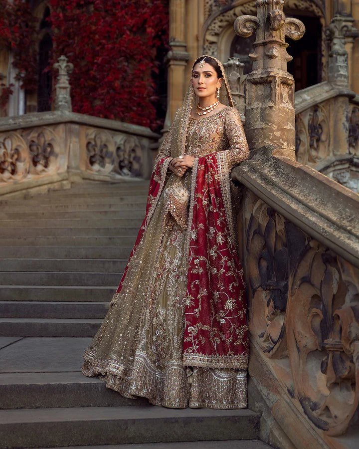 Model wearing a red and gold Ghina bridal dress by Faiza Saqlain featuring intricate embroidery, ideal for Pakistani weddings, available online in the UK.