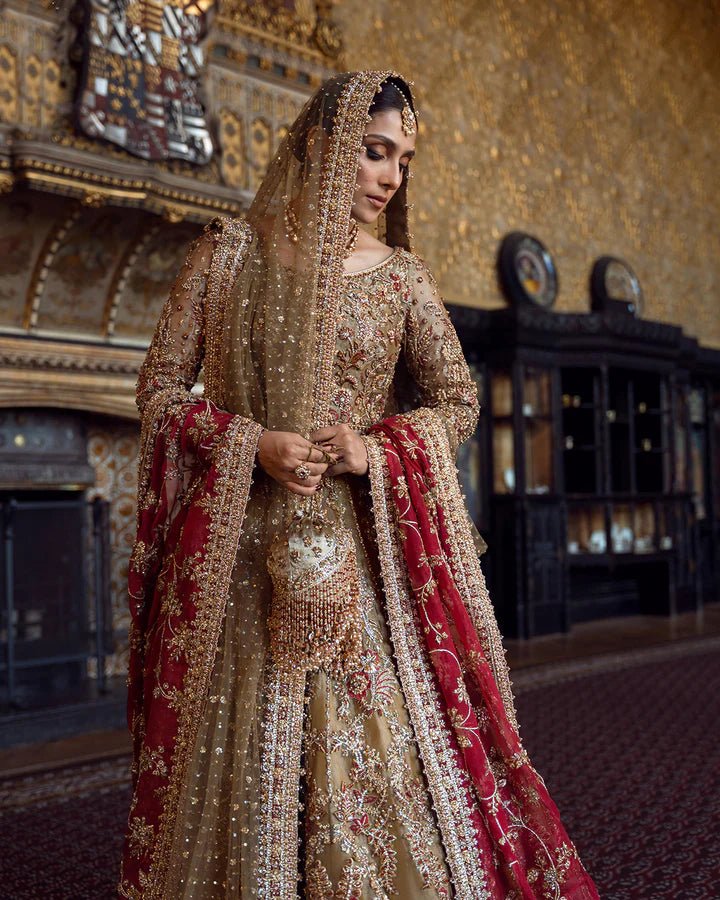 Model wearing a red and gold Ghina bridal dress by Faiza Saqlain featuring intricate embroidery, ideal for Pakistani weddings, available online in the UK.