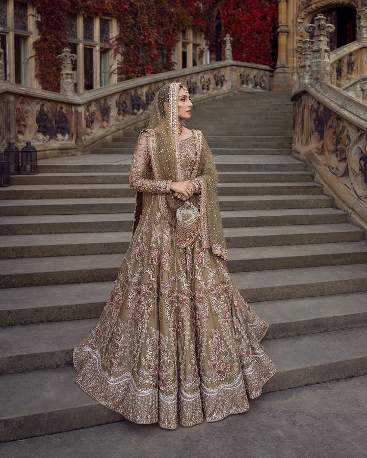 Model wearing a red and gold Ghina bridal dress by Faiza Saqlain featuring intricate embroidery, ideal for Pakistani weddings, available online in the UK.