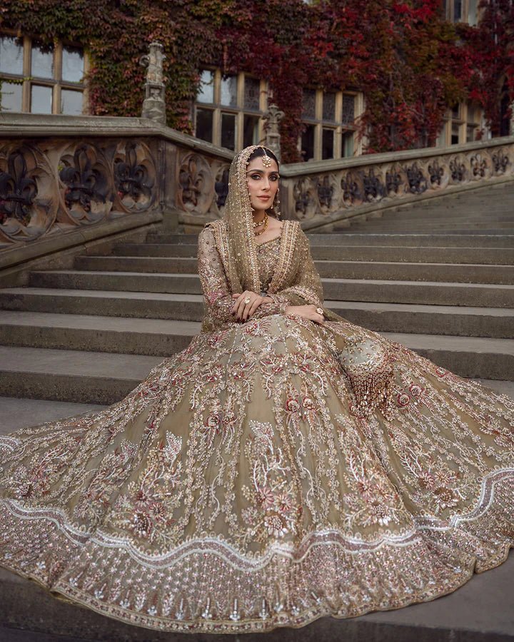 Model wearing a red and gold Ghina bridal dress by Faiza Saqlain featuring intricate embroidery, ideal for Pakistani weddings, available online in the UK.