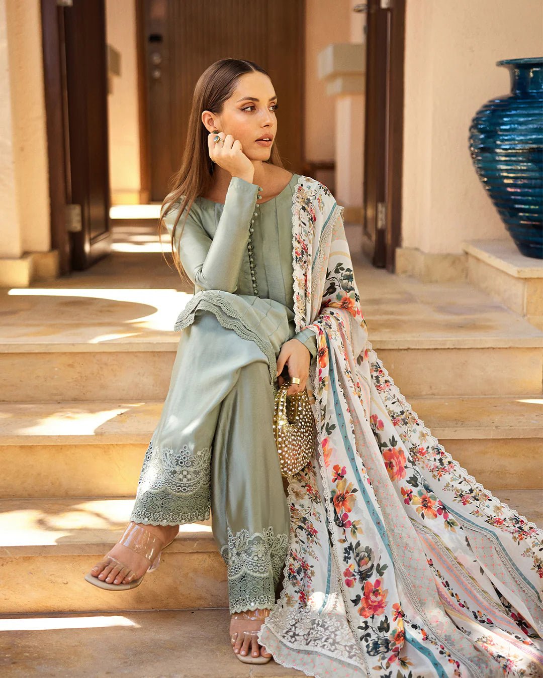 Model wearing Faiza Saqlain Carmela Arnett dress in sage green with a floral printed white dupatta. Shop Pakistani bridal dresses online in the UK now.